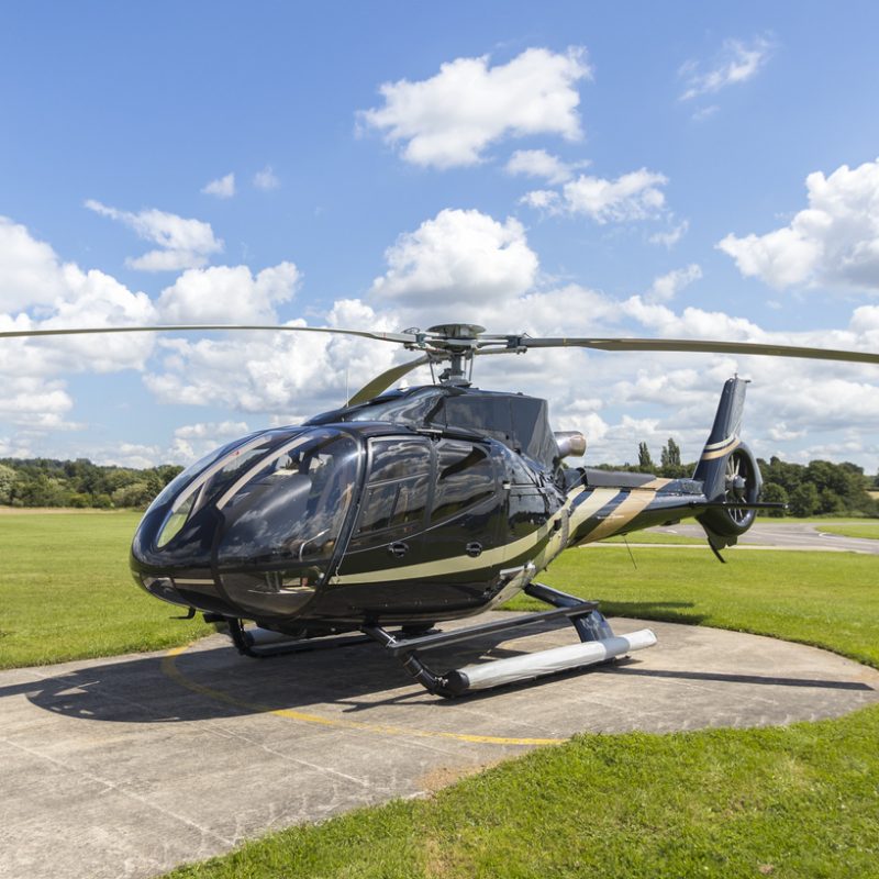 Eurocopter EC130B4 on hard standing at grass airfield